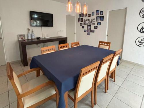 a dining room with a blue table and chairs at NEFELI departamento by Xenia Caribe in Playa del Carmen