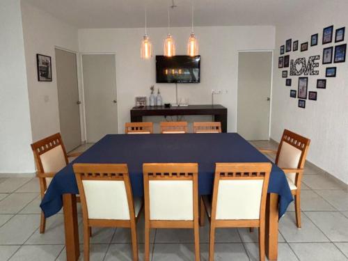 a dining room with a blue table and chairs at NEFELI departamento by Xenia Caribe in Playa del Carmen