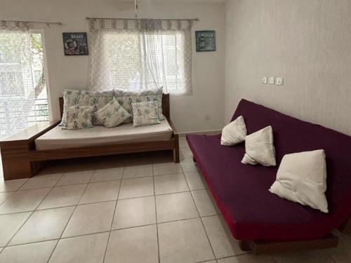 a living room with two beds and a window at NEFELI departamento by Xenia Caribe in Playa del Carmen