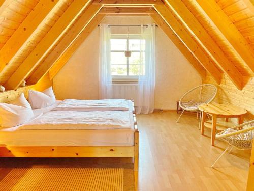 a bedroom with a bed and a window and a table at Eisvogel in Lübbenau