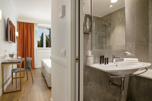 a bathroom with a sink and a toilet in a room at Hotel Shangri-La Roma by OMNIA hotels in Rome