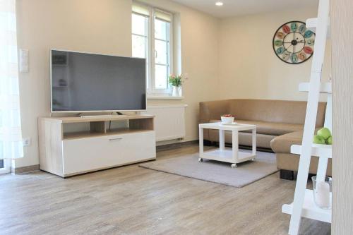 a living room with a large flat screen tv at Quartier Spreestraße - App 4 in Burg