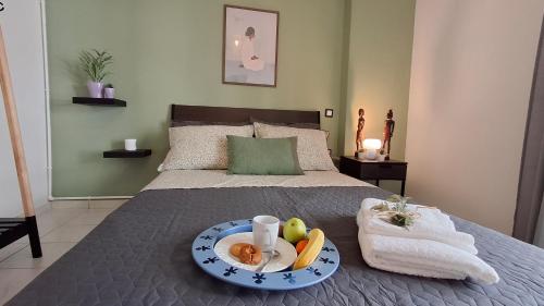 a tray of fruit on a bed in a bedroom at SweetHome Komotini central & comfy apartment with Parking in Komotini