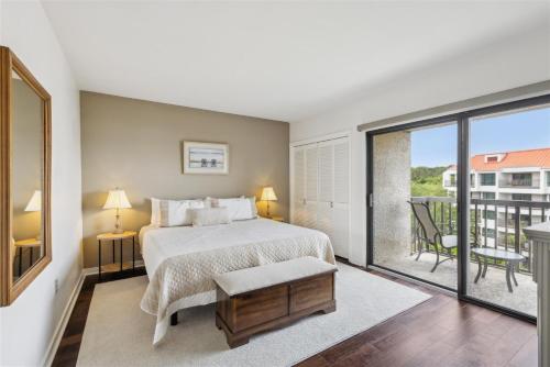 a bedroom with a bed and a balcony at 261 Captains Quarters in Hilton Head Island