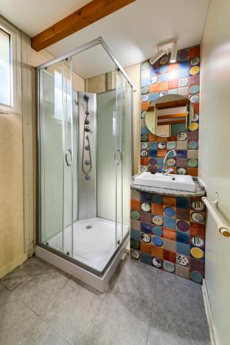 a shower stall in a bathroom with a tile wall at Bungalows & Glamping Conil Playa in Conil de la Frontera