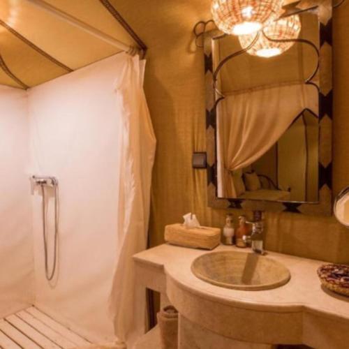 a bathroom with a sink and a shower at Overnight Luxury Camp in Merzouga