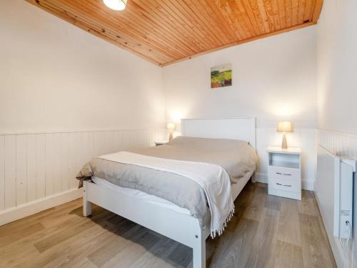 a bedroom with a white bed and a wooden ceiling at 3 Bed in Roundstone oc-i234 in Callow