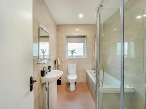 a bathroom with a toilet and a sink and a shower at 3 Bed in Roundstone oc-i234 in Callow