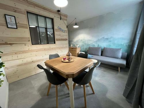 une salle à manger avec une table et un canapé dans l'établissement L'ourson B2, à La Bresse