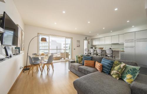 a living room with a couch and a table and a kitchen at B19 - Marina Club Apartment in Lagos