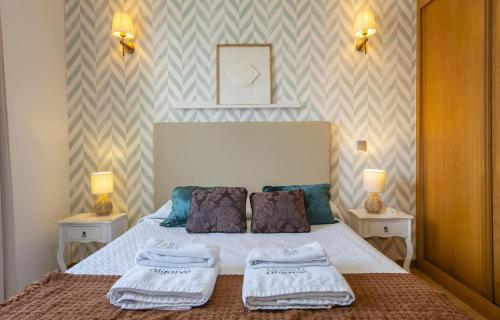 a bedroom with a bed with two pillows on it at B19 - Marina Club Apartment in Lagos