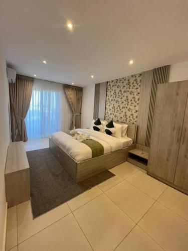 Vuode tai vuoteita majoituspaikassa Prime Aura Properties