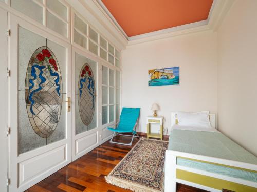 a bedroom with a bed and stained glass windows at Acropol Seaview Apartment in Corfu Old Town by the Old Port in Corfu