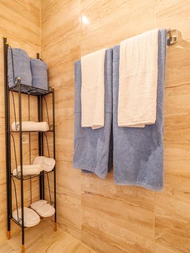 a bunch of towels hanging on a wall in a bathroom at Acropol Seaview Apartment in Corfu Old Town by the Old Port in Corfu
