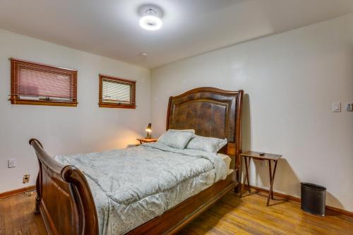 a bedroom with a large bed with a wooden headboard at Pool Table & Shared Sauna! Potomac River Basecamp in Westernport