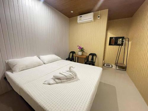a bedroom with a bed with a towel on it at Kasyatel in Impasugong