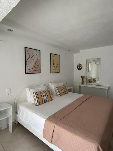 a bedroom with a large white bed with two pillows at Fiosal Apartments 2 in Skiathos