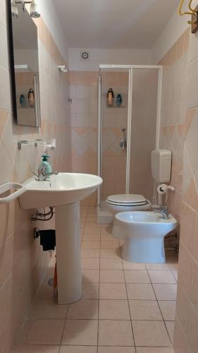 a bathroom with a sink and a toilet at Casa Danero "U dabassu" - Centro storico di Carloforte in Carloforte