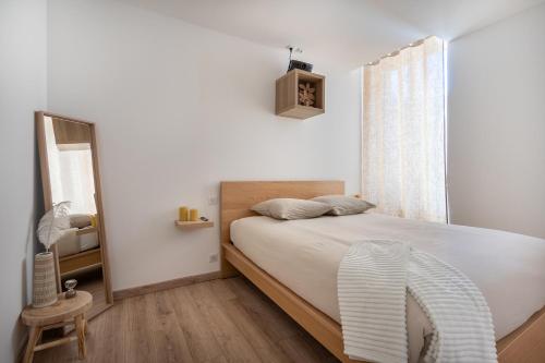 a bedroom with a large bed and a window at L'escale Mourillon - Plage, Balnéo & Soleil in Toulon