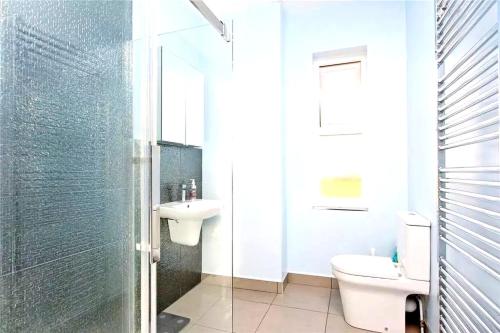 a white bathroom with a toilet and a sink at Group Accommodation - Rushden A6 Manor House - Private Gated -Sleeps 15 - Secure Parking in Rushden