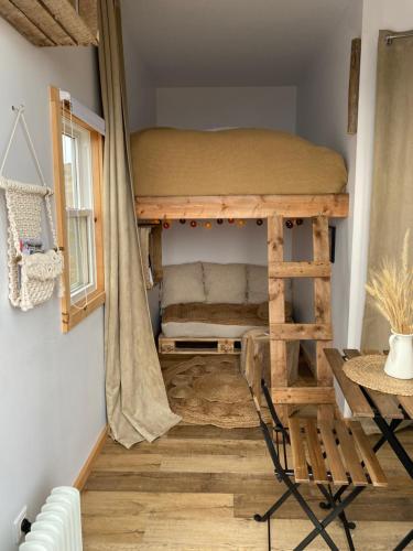 a bedroom with a bunk bed in a room at Les Cabanes du Cap in Miquelon