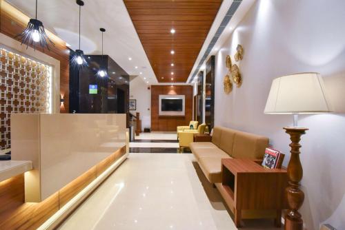 a lobby with a couch and a table at SureStay by Best Western Heritage Walk in Amritsar