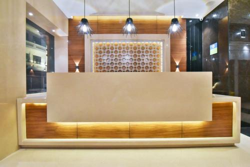 a reception desk in a room with lights at SureStay by Best Western Heritage Walk in Amritsar