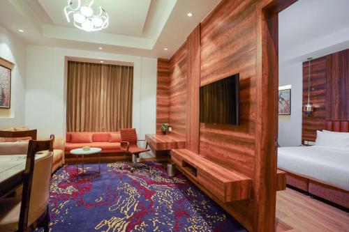 a hotel room with a bed and a tv at Best Western Vrindavan in Vrindāvan