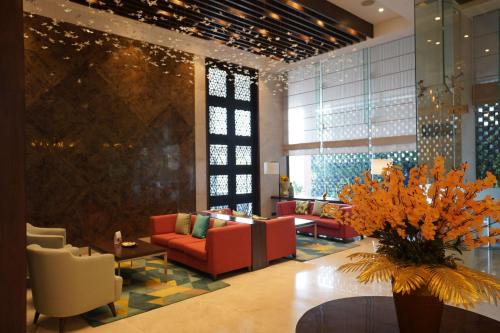 a lobby with a couch and chairs and a table at Best Western Plus Chandigarh Mohali in Mohali