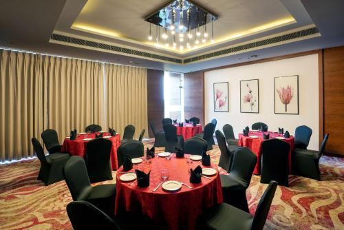 a conference room with tables and chairs and a chandelier at Best Western Plus Chandigarh Mohali in Mohali