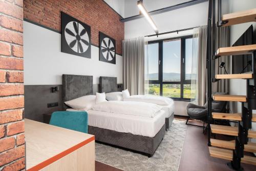 a bedroom with a bed and a brick wall at Best Western Hotel Presov in Prešov