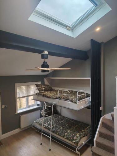 a room with two bunk beds and a skylight at Tramway Apartment in Blessington