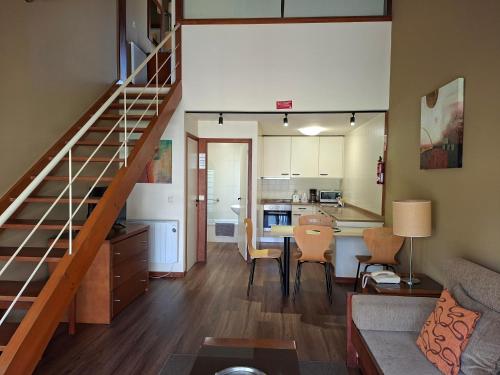 a living room with a staircase leading to a kitchen at Clube Pinhal da Foz in Esposende