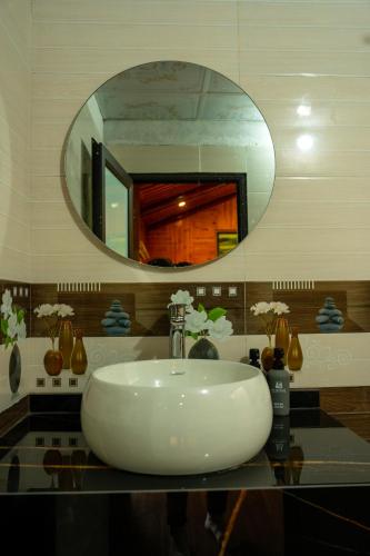 a bathroom with a white sink and a mirror at Bản Mận Retreat in Sapa