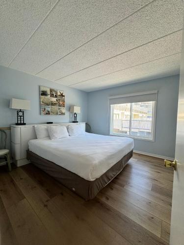 a bedroom with a large bed and a window at Wild Dunes Inn in Ocean City