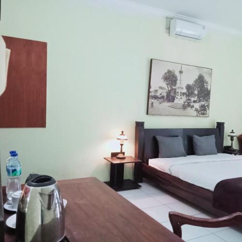 a hotel room with a bed and a table at Palagan Boutique Hotel in Ngaglik