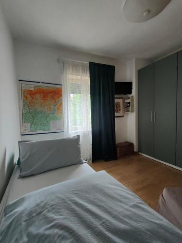 a bedroom with a large bed and a window at Piccolo Appartamento Casa Vacanze B&B Angela in Clusone