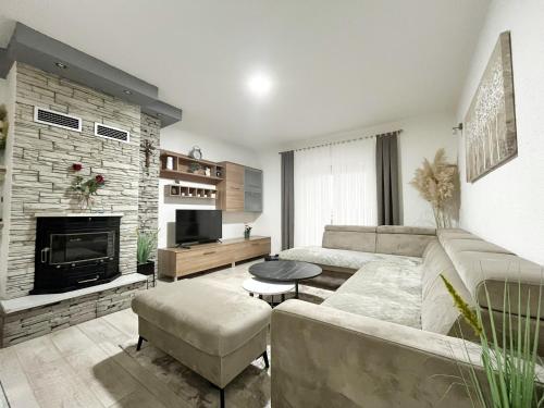 a living room with a couch and a fireplace at Villa Prima Natura Imotski, private pool in Imotski
