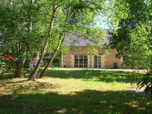 a brick house with trees in front of it at Modern and comfortable home with swimming pool in Dezéjoul