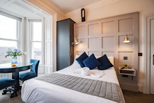 a bedroom with a large bed with a table and chairs at Superb Marina Hideaway- With kitchen and Wi-Fi in Dublin