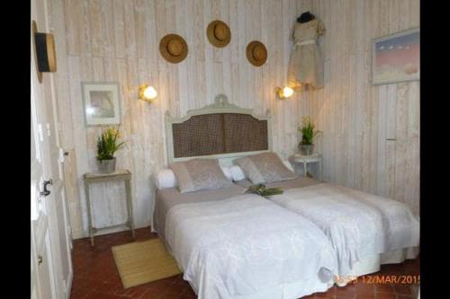 a bedroom with a large white bed in a room at La Maison du Chichui in Orgon