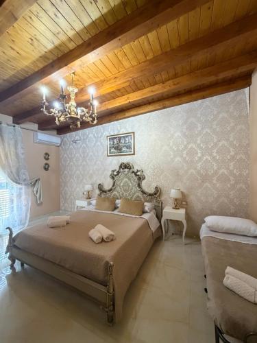 a bedroom with a large bed with a chandelier at B&B temptation in CTA