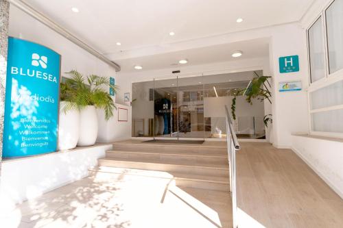 a store front with a blue stress sign and plants at BLUESEA Mediodia in El Arenal