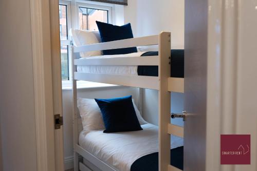 a couple of bunk beds in a room at Hook Three Bed Flat Parking in Hook