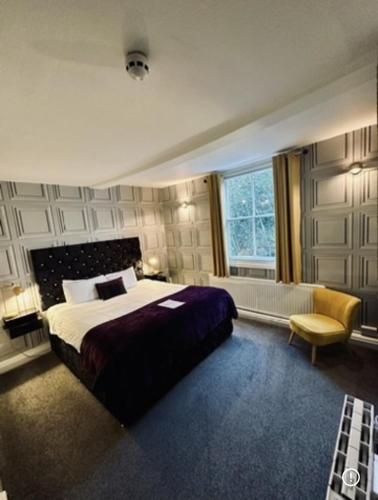 a bedroom with a large bed and a window at The Forest Lodge in Edwinstowe