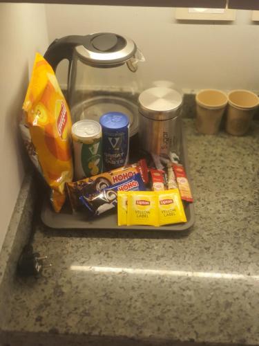 a tray filled with food and drinks on a counter at Luxury hotel APT Sheikh Zayed, PVT entrance,garden in Sheikh Zayed
