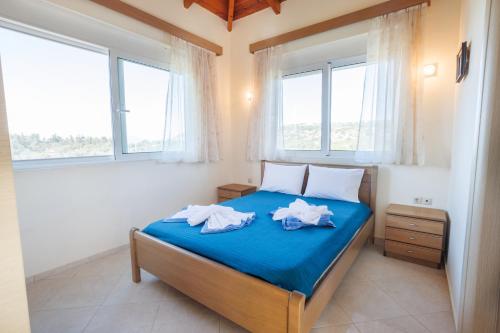 a bedroom with a bed with two towels on it at Villa Sofia Almyrida in Almyrida
