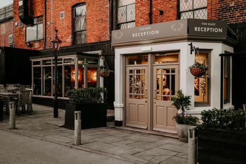 a restaurant with a door in front of a building at The Hart in Uttoxeter