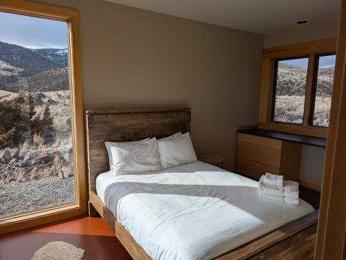 a bedroom with a bed and a large window at Erik's Ranch in Livingston