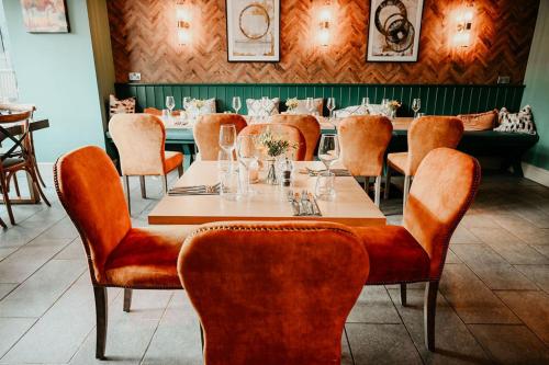 a dining room with a table and chairs at The Hart in Uttoxeter